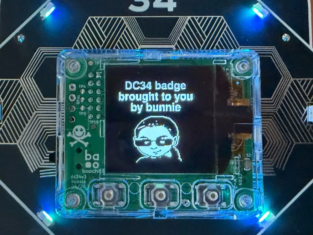 Center module with screen showing DC34 badge by bunnie